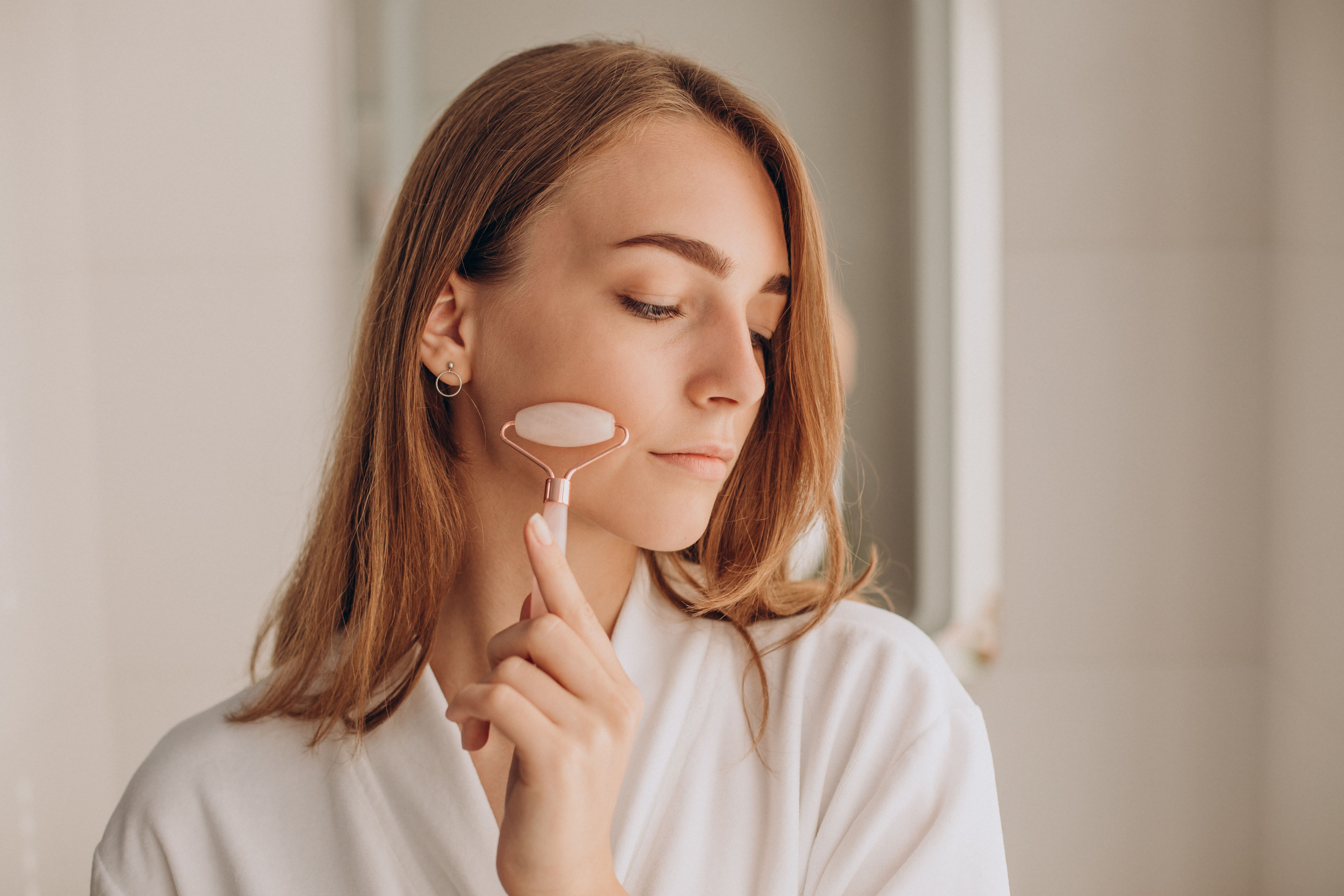 woman-doing-self-massage-with-rose-quartz-face-roller-1