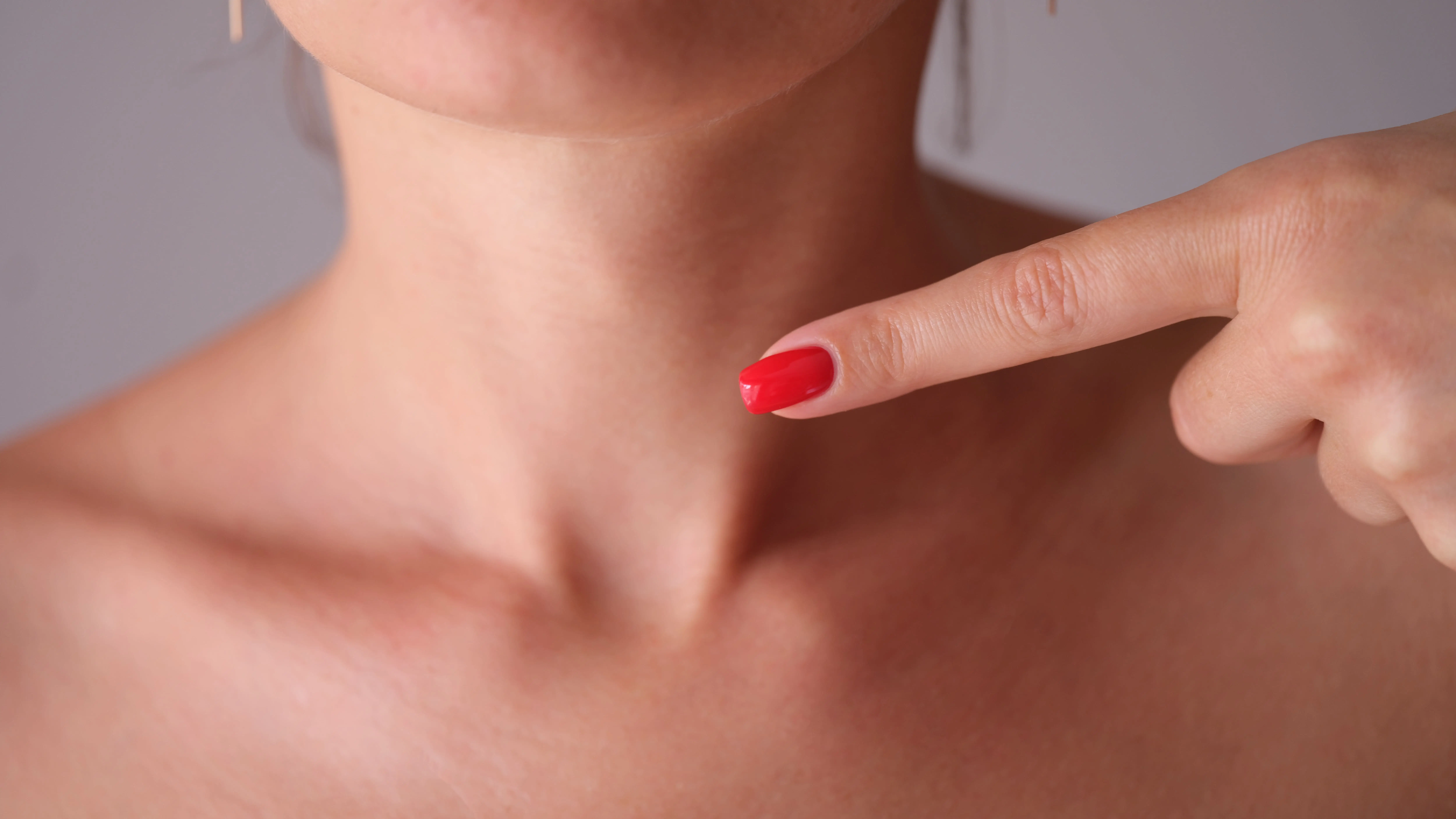 young-woman-pointing-her-finger-neck-closeup-1-1